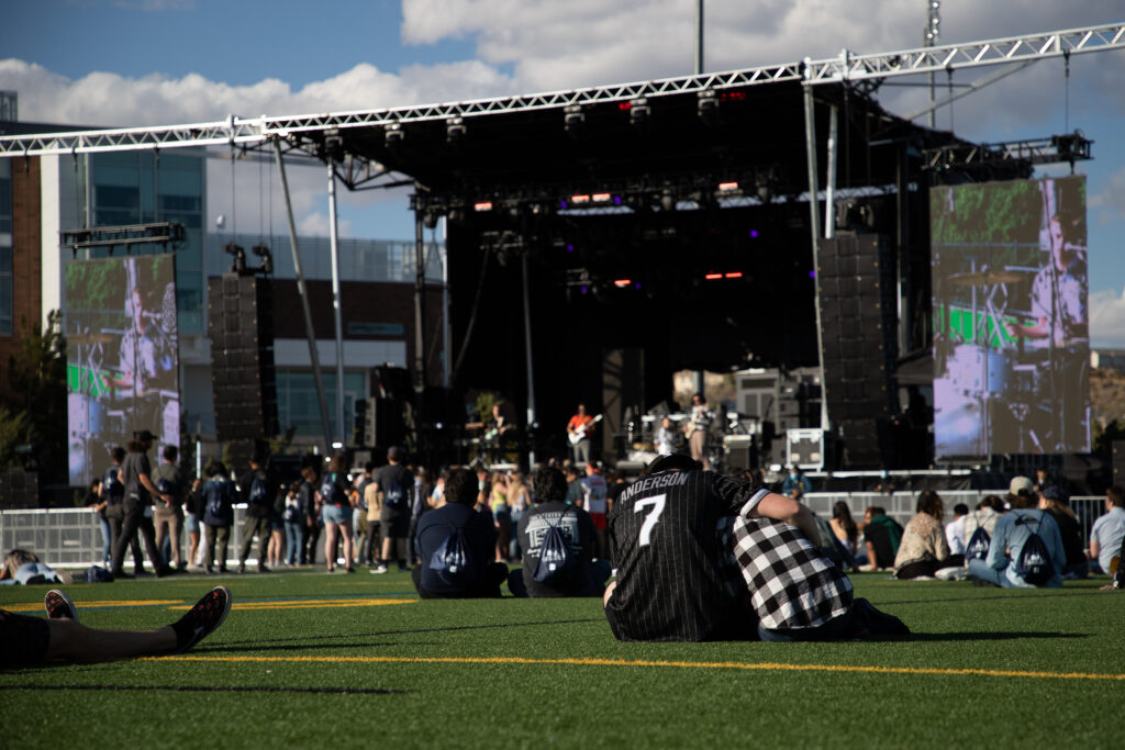 Students gather for a mellow time on the grass in front of the stage at the ASUN festival.