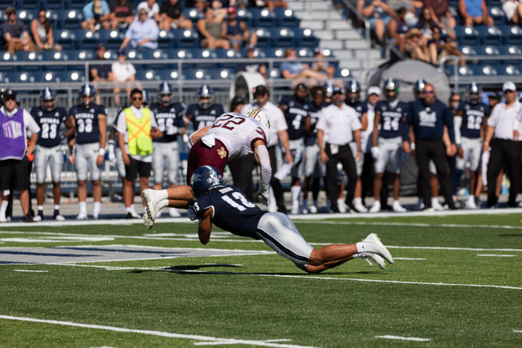 Zeke Robbins grabs the ball from a Texas State team member.