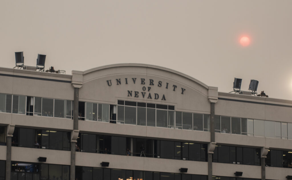 A building that read University of Nevada with a sky filled with smoke