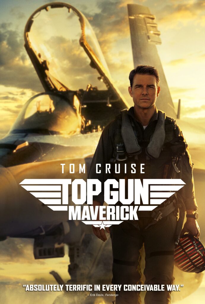 Tom Cruise stands walking in slow motion with a plan behind him, holding a helmet with the title "Top Gun: Maverick" in front of him.