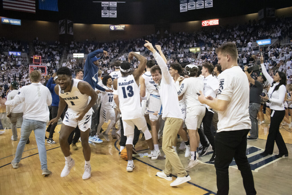 Nevada basketball players celebrate their victory on the basketball court
