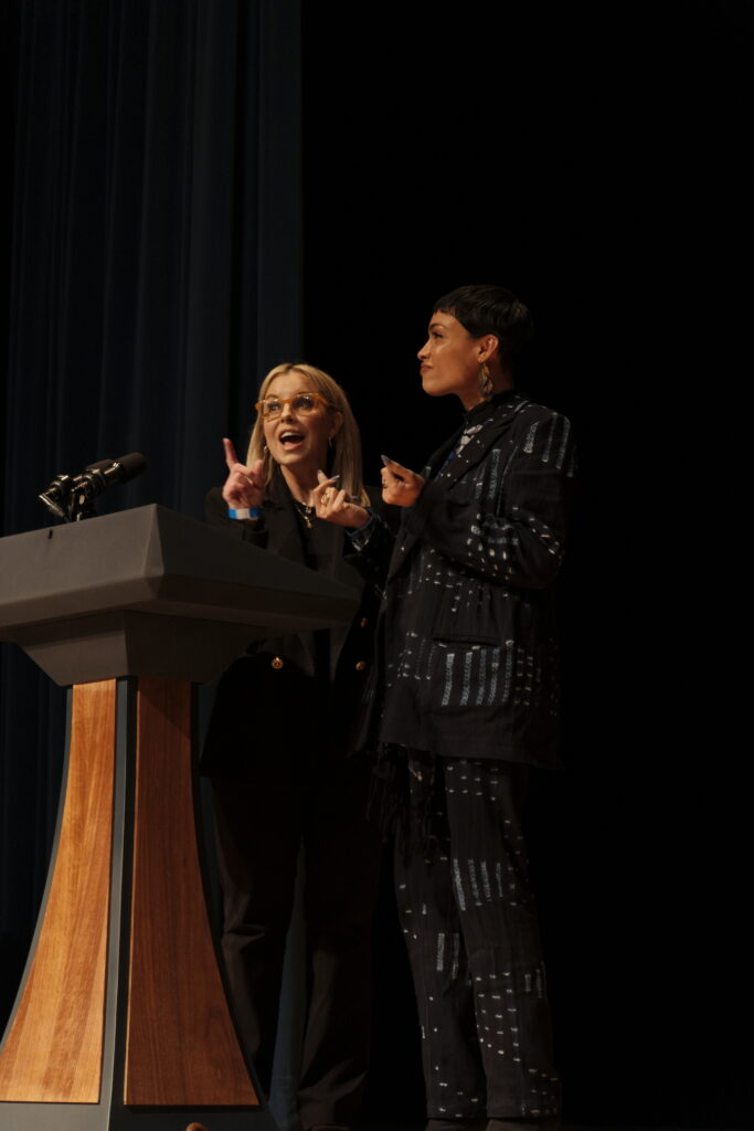 Hillary Schieve and Rosario Dawson speak on stage