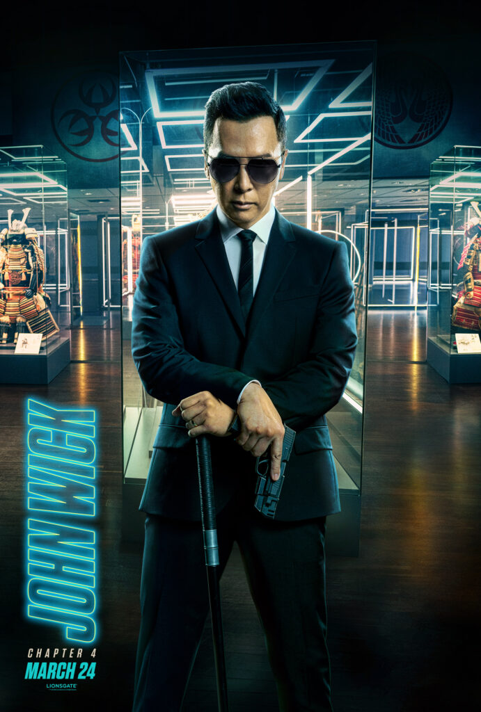 A character poster of Donnie Yen in a suit and sunglasses.