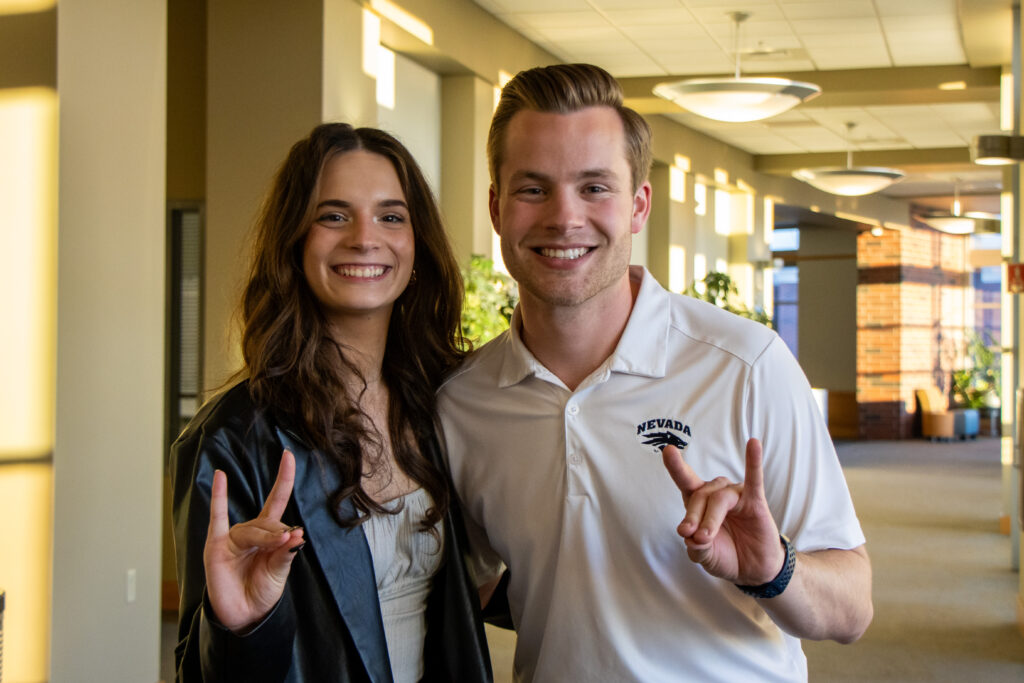 Dawson Deal and Liesel Kemmelmeier pose for post-election photos holding up WolfPack hand sign.