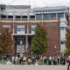 Students stand in front of the Joe Crowley Student Union