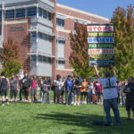 Daniel John Lee stands in front of the Joe Crowley spouting his beliefs to students holding up a poster about sinners on October 4, 2022.