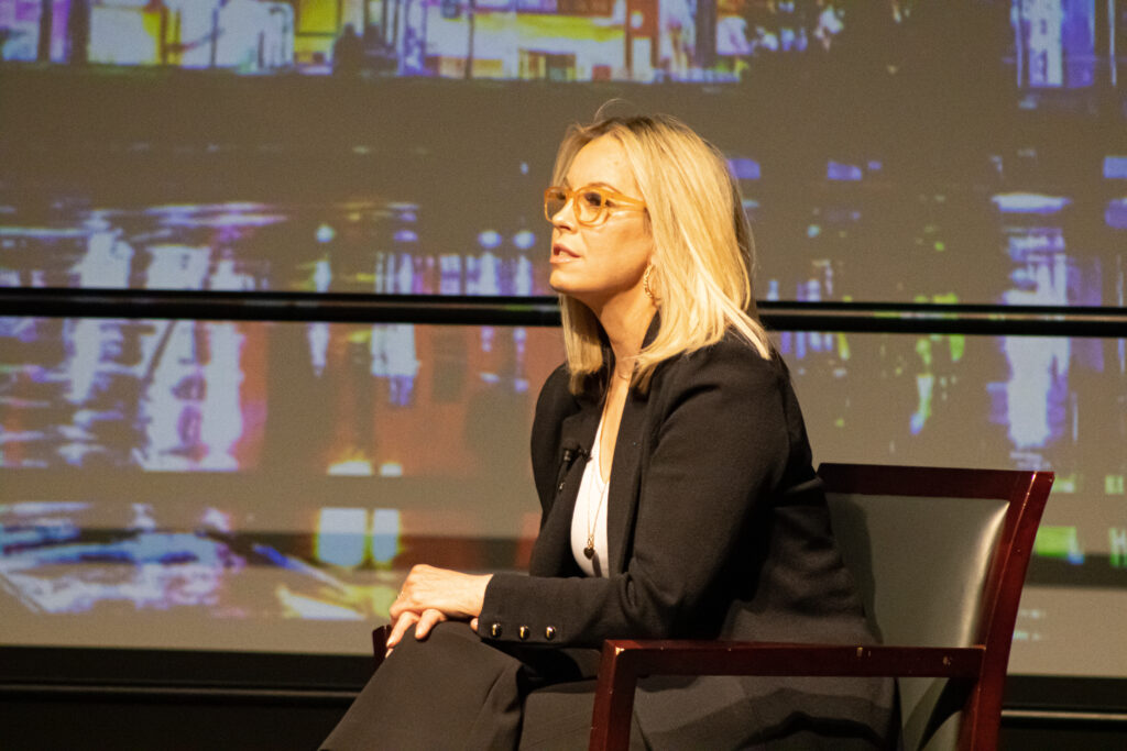 Mayor Hillary Schieve sitting on the stage of the Joe Crowley Student Union's Milt Glick Ballrooms. 