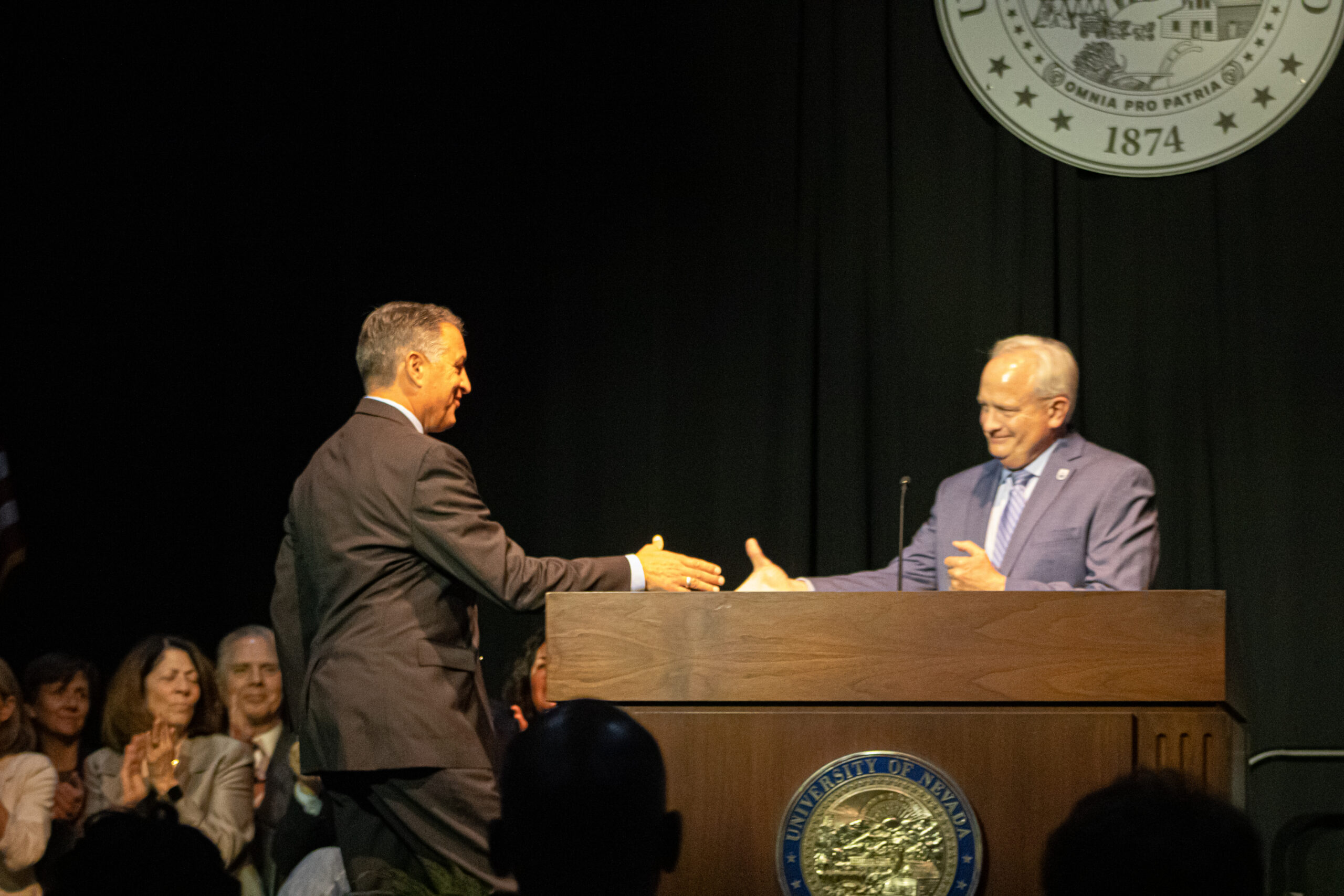 President Brian Sandoval at the University of Nevada, Reno shakes has with Vice Provost Jeff Thompson at the State of the University on Oct. 17.