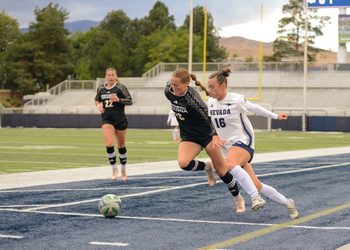 Wolf Pack forward Olivia Loomis (#16) takes on a Lumberjacks defender on Thursday, Sept. 3 at Mackay Stadium.