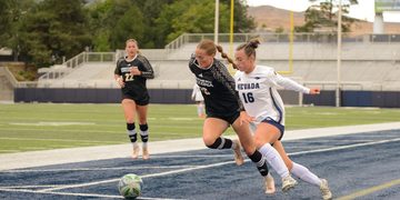 Wolf Pack forward Olivia Loomis (#16) takes on a Lumberjacks defender on Thursday, Sept. 3 at Mackay Stadium.