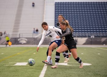Nevada forward Carmen Coronado (#5) takes on two Northern Arizona defenders on Thursday, Sept. 3 at Mackay Stadium