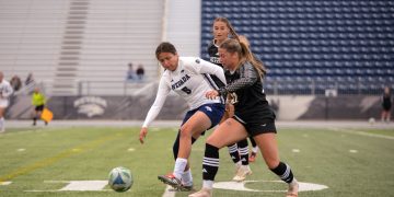 Nevada forward Carmen Coronado (#5) takes on two Northern Arizona defenders on Thursday, Sept. 3 at Mackay Stadium