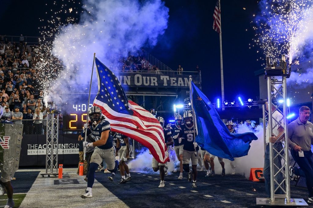 Nevada linebacker Jake Silverman and Nevada wide receiver Marshaun Brown lead the Pack out of the tunnel prior to their matchup against the Montana State Bobcats at Mackay Stadium on Saturday, Sept. 12.