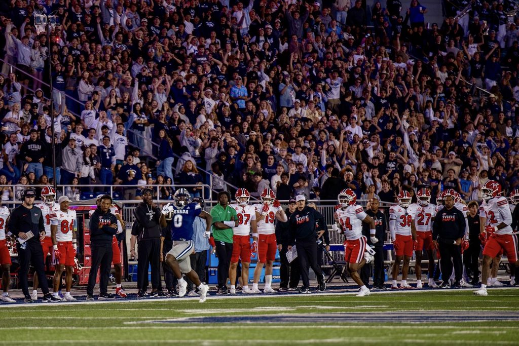 Nevada running back Dom Kelley (#0) speeds past Western Kentucky's sideline towards the endzone for a 72-yard touchdown at Mackay Stadium on Saturday, Sept. 5.