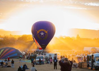 The famous Battle Born balloon, piloted by Pat Irwin, idles on the field in front of the rising sun during the Great Reno Balloon Race on Thursday, Sept. 10.