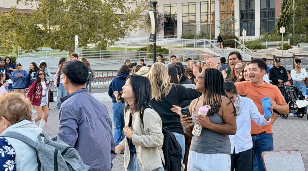 Attendees high-fiving each other on the Joe Crowley Student Union Plaza.