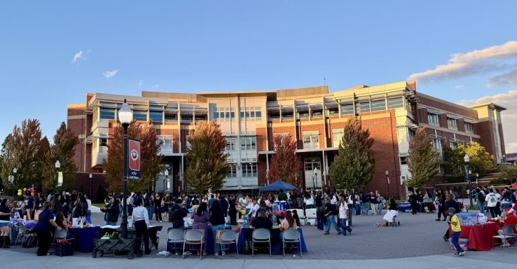 Organizers and attendees participating in Tu Bienvenida at the Joe Crowley Student Union Plaza.