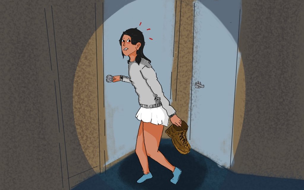 Ella Mayo cautiously sneaking from the door of a dorm room.