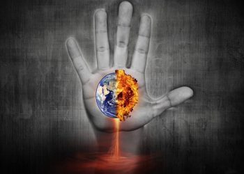 An image of a hand reaching up towards a burning Earth.
