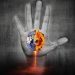 An image of a hand reaching up towards a burning Earth.