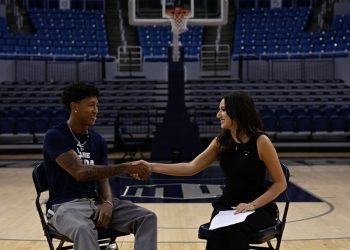 Nevada basketball junior guard TJ Coulter shakes hands with Nevada Sagebrush reporter Sophia Domingo during an interview.