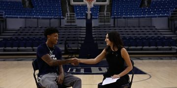 Nevada basketball junior guard TJ Coulter shakes hands with Nevada Sagebrush reporter Sophia Domingo during an interview.