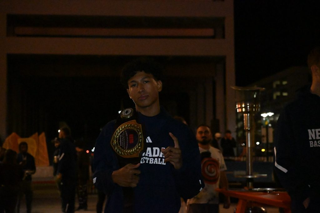 Junior guard TJ Coulter shows off his 3-point contest champion belt.