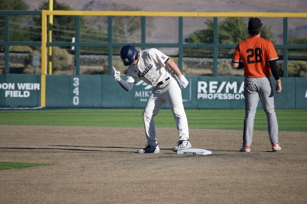Junior utility player Sam Kane celebrates his double hit on Saturday, Oct. 17.