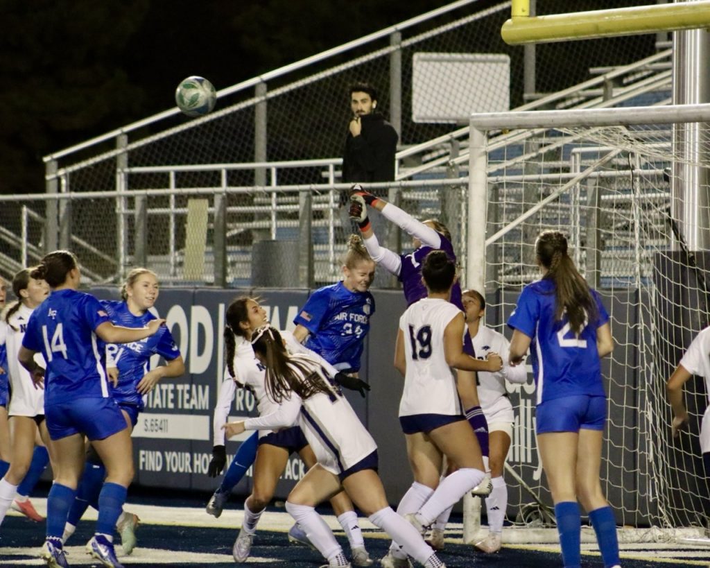 Fifth year goalkeeper Mia Collins jumps up to punch out a ball off an Air Force corner kick at Mackay Stadium on Sunday, Oct. 18.