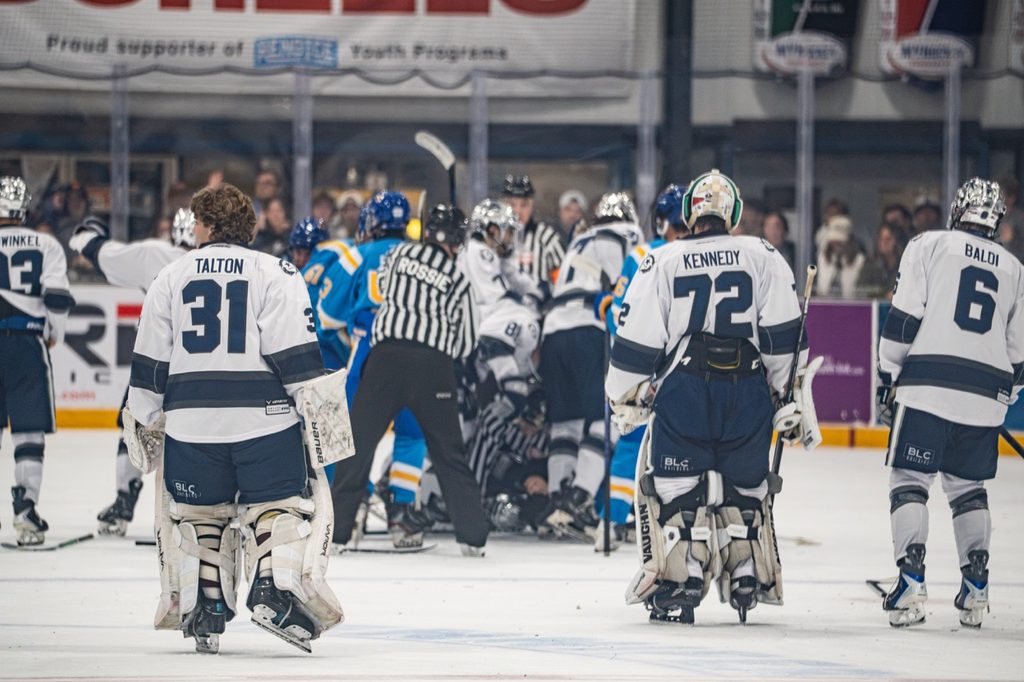 Nevada hockey players Talton (#31), Kennedy (#72) and Baldi (#6) watch as their teammates brawl with the visiting Bruins players on Oct. 9 at Reno Ice. 