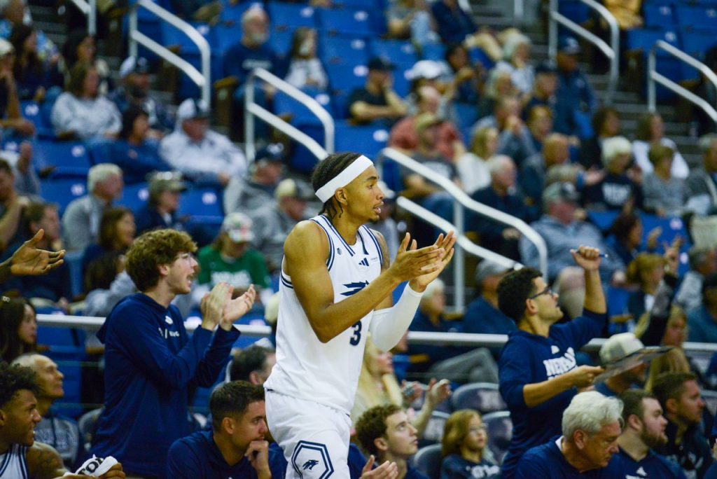Redshirt junior Elijah Price comes off the bench cheering at Lawlor Event Center on Sunday, Oct. 25.