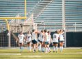 Sophomore forward Ella Hallert (#8) poses with her team after her goal on Saturday, Oct. 3.