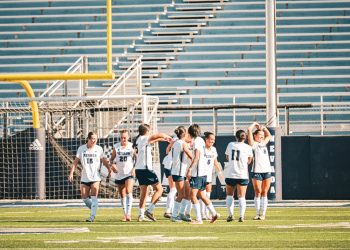 Sophomore forward Ella Hallert (#8) poses with her team after her goal on Saturday, Oct. 3.
