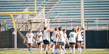 Sophomore forward Ella Hallert (#8) poses with her team after her goal on Saturday, Oct. 3.