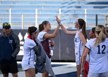 Nevada women's club soccer heads to the sidelines for halftime. Teammates, junior midfielder Jenna Bartorelli and junior defender Caysie Baker, high-five to celebrate a good first half.