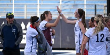 Nevada women's club soccer heads to the sidelines for halftime. Teammates, junior midfielder Jenna Bartorelli and junior defender Caysie Baker, high-five to celebrate a good first half.