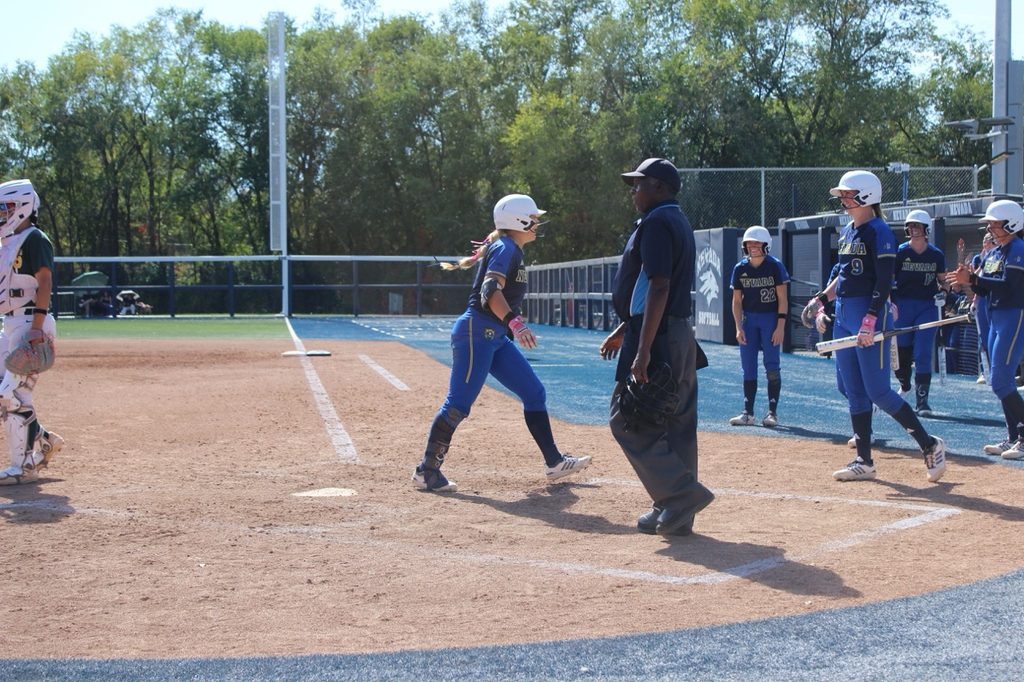 Nevada softball's dugout steps out to celebrate a run home on Saturday, Oct. 3