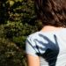 A shadow hand over a girl's shoulder