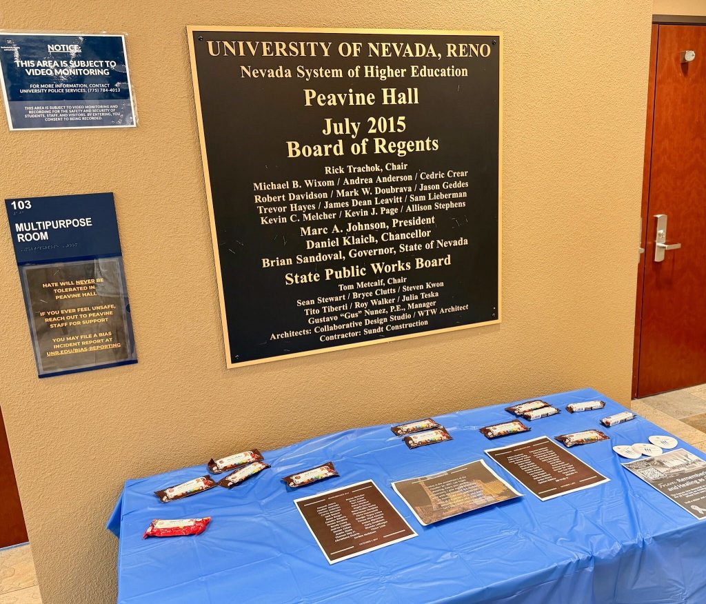 Candy bars distributed inside the first floor of Peavine Hall, sitting on a table with flyers.