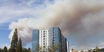 Smoke looms over a student apartment building.