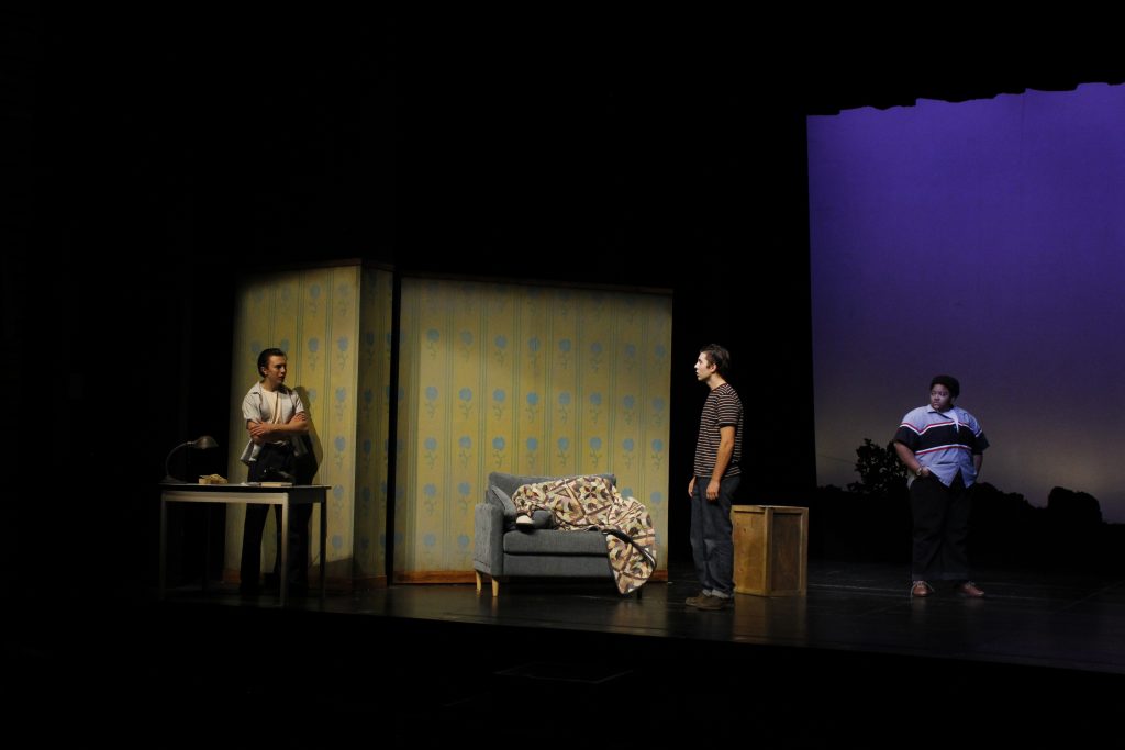 Actors inside a house conversing with tension.