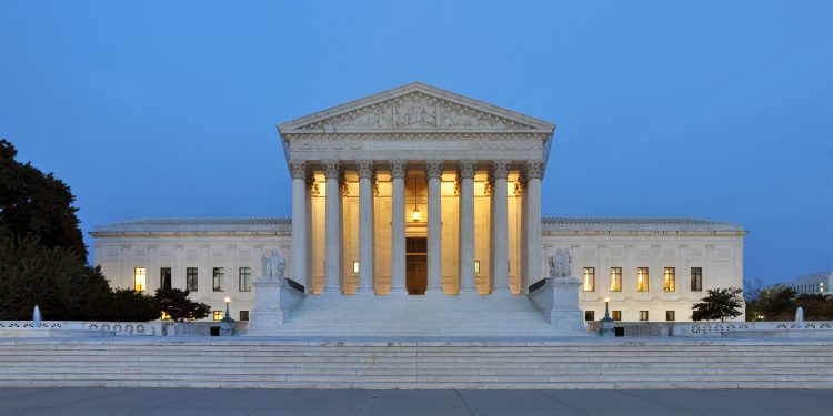The United State Supreme Court building at dusk.