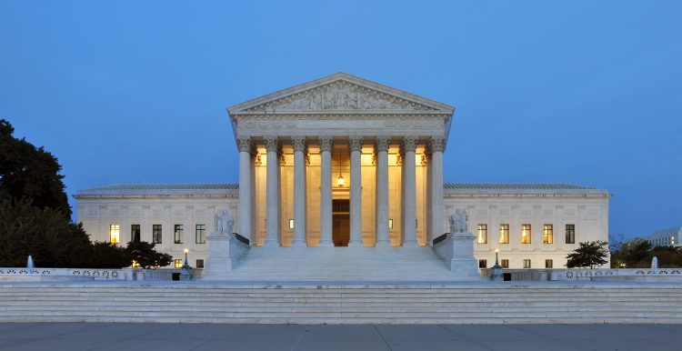 The United State Supreme Court building at dusk.