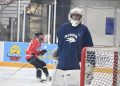 Nevada men's hockey goalie looks to the sidelines as the team warms up.