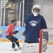 Nevada men's hockey goalie looks to the sidelines as the team warms up.