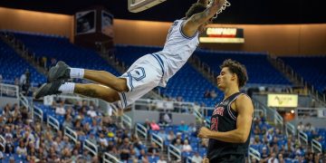 Nevada senior forward Vaughn Weems dunks the ball over Utah freshman forward Alec Anigbata  at Lawlor Events Center on Saturday, Oct. 17.