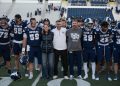 University of Nevada, Reno president Brian Sandoval, along side the University's first lady Lauralyn Sandoval and Nevada football head coach Jeff Choate celebrate the win along side players, cheerleaders and mascots on Saturday, Oct. 24 at Mackay Stadium.