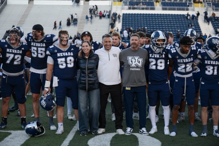 University of Nevada, Reno president Brian Sandoval, along side the University's first lady Lauralyn Sandoval and Nevada football head coach Jeff Choate celebrate the win along side players, cheerleaders and mascots on Saturday, Oct. 24 at Mackay Stadium.