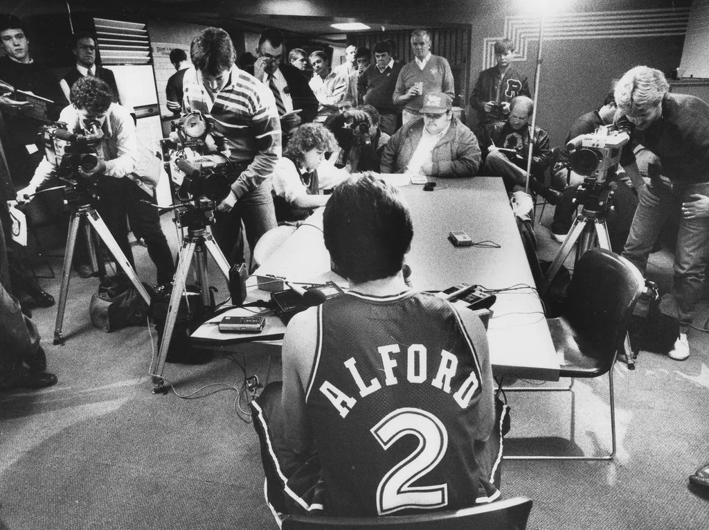 Alford taking questions from reporters while on the Dallas Mavericks.