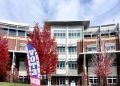 A flag reading “Vote Here” in front of the Joe Crowley Student Union on Oct. 29, 2026.